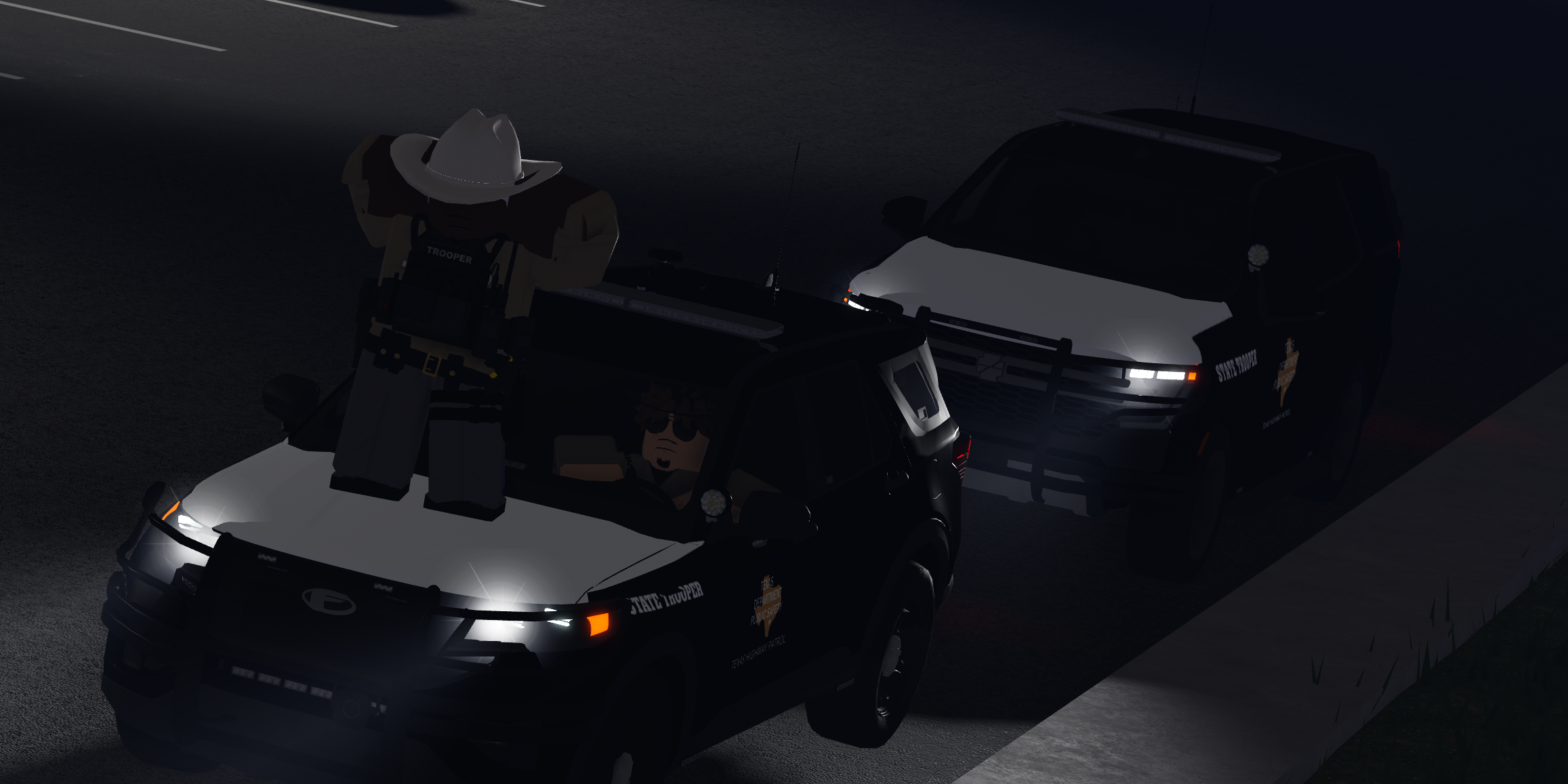 Texas state troopers with Department of Public Safety patrol vehicles at night